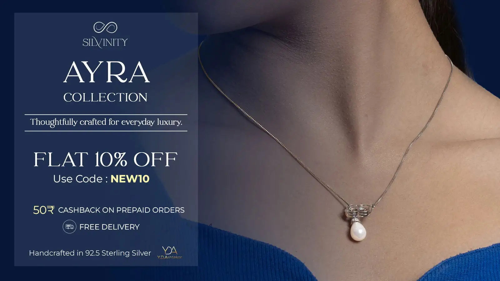 A delicate silver necklace with a single pearl pendant, featuring a small diamond accent at the top.