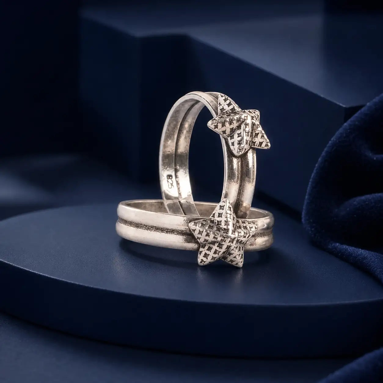 Silver star-shaped ring with a textured, grid-patterned design on the star’s surface.